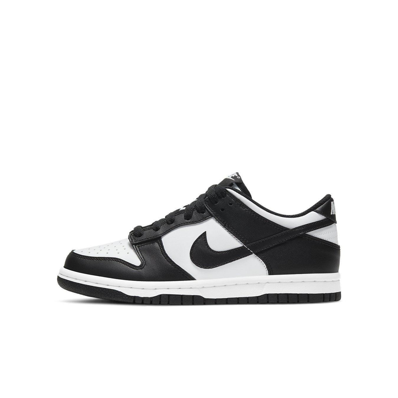 Nike Dunk Low Retro White Black GS sneaker with a leather upper featuring a white base and black overlays.