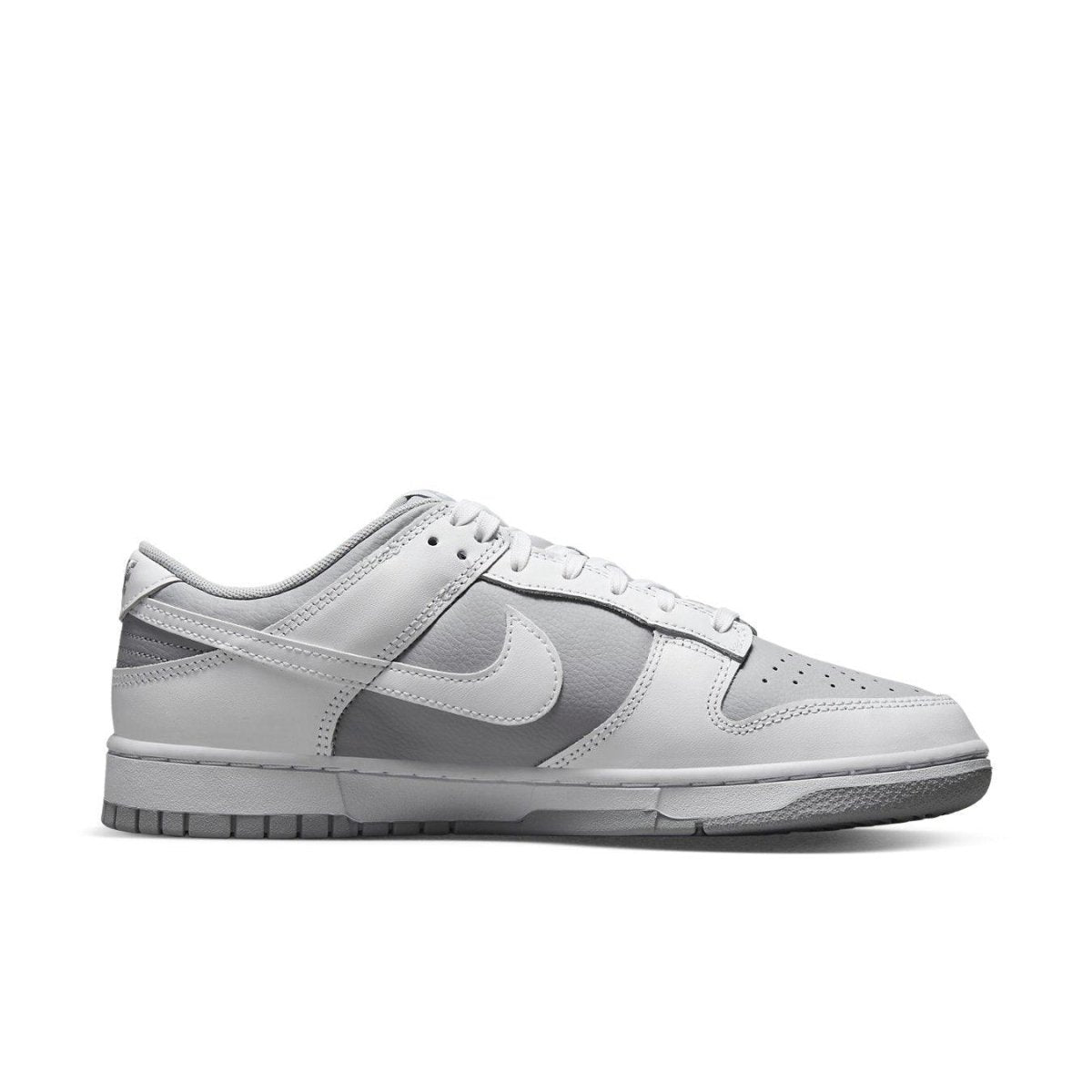 Nike Dunk Low Retro in White and Grey, showcasing a timeless sneaker design with classic color blocking.
