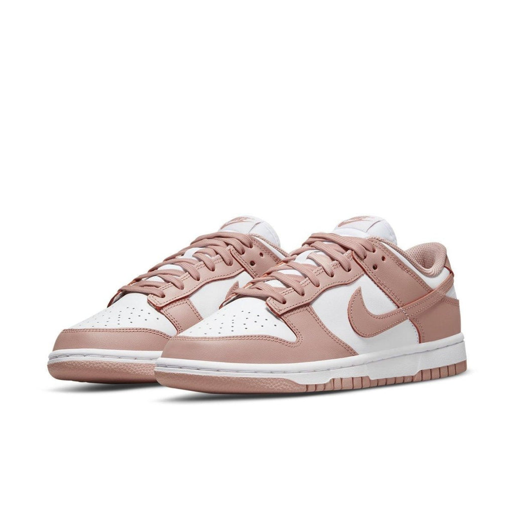 Nike Dunk Low Rose Whisper sneakers in pink and white, featuring classic two-tone design and feminine touches.