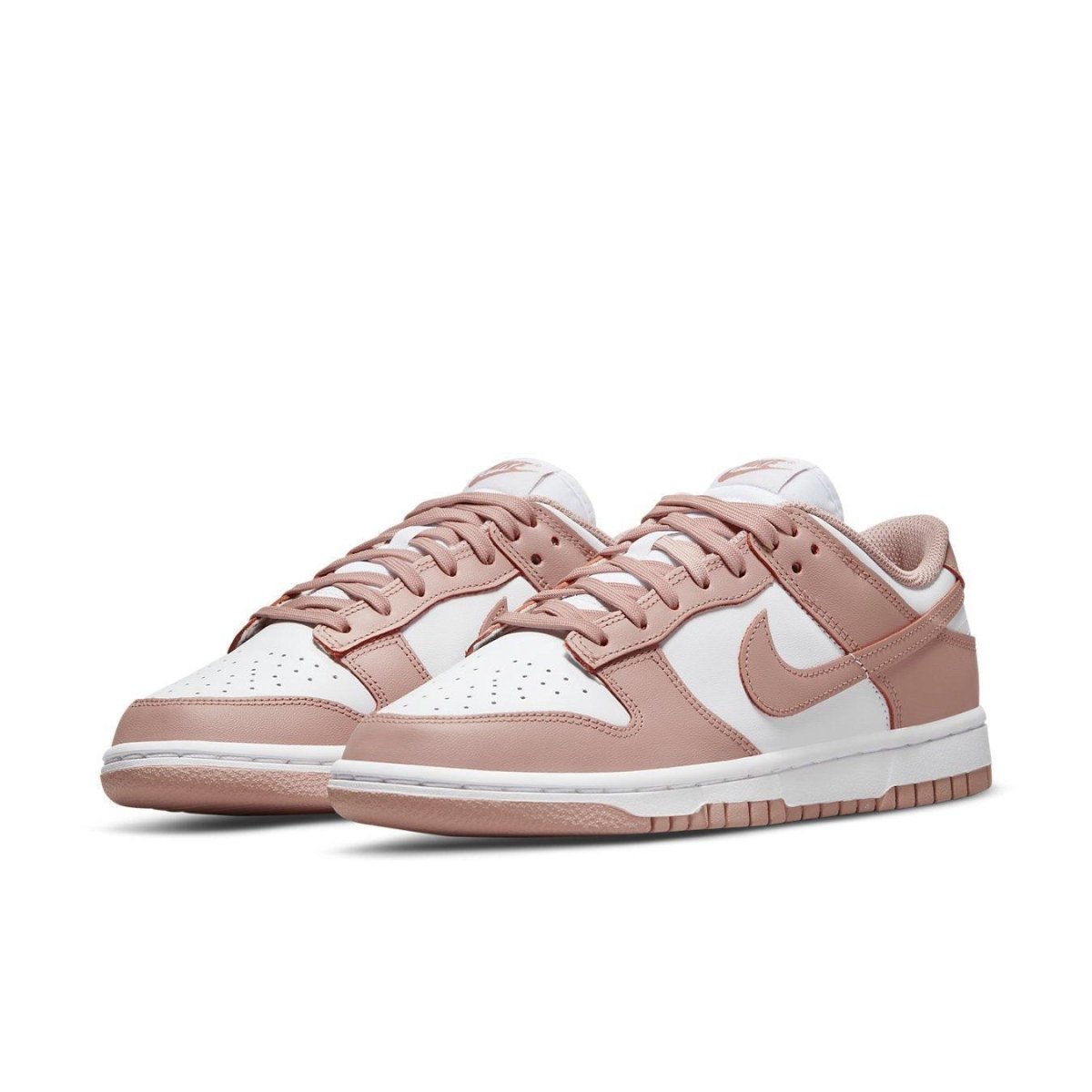 Nike Dunk Low Rose Whisper sneakers in pink and white, featuring classic two-tone design and feminine touches.