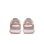 Nike Dunk Low Rose Whisper (W) sneakers showing the back view with soft pink hues and classic Nike branding.