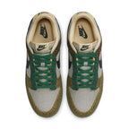 Nike Dunk Low Safari Golden Moss shoes featuring earthy tones, black Swoosh, and emerald green laces.