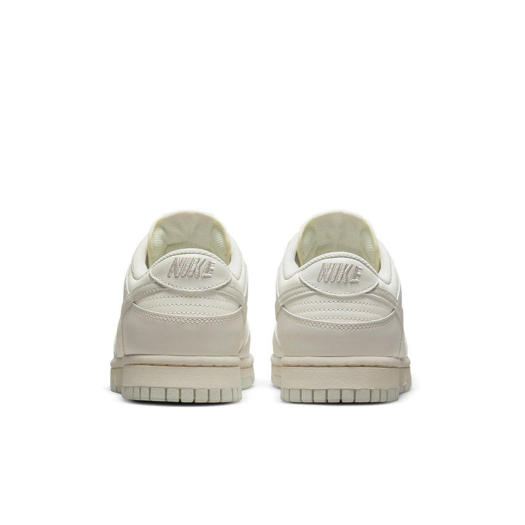 Nike Dunk Low Sail Light Bone (W) back view showing sleek design and branding details.