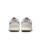 Rear view of the Nike Dunk Low SE 85 Sail Orange sneakers showcasing neutral colors and signature branding.