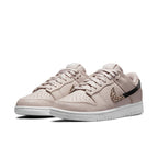 Nike Dunk Low SE Animal Instinct Fossil Stone women’s sneakers with animal print and metallic accents.