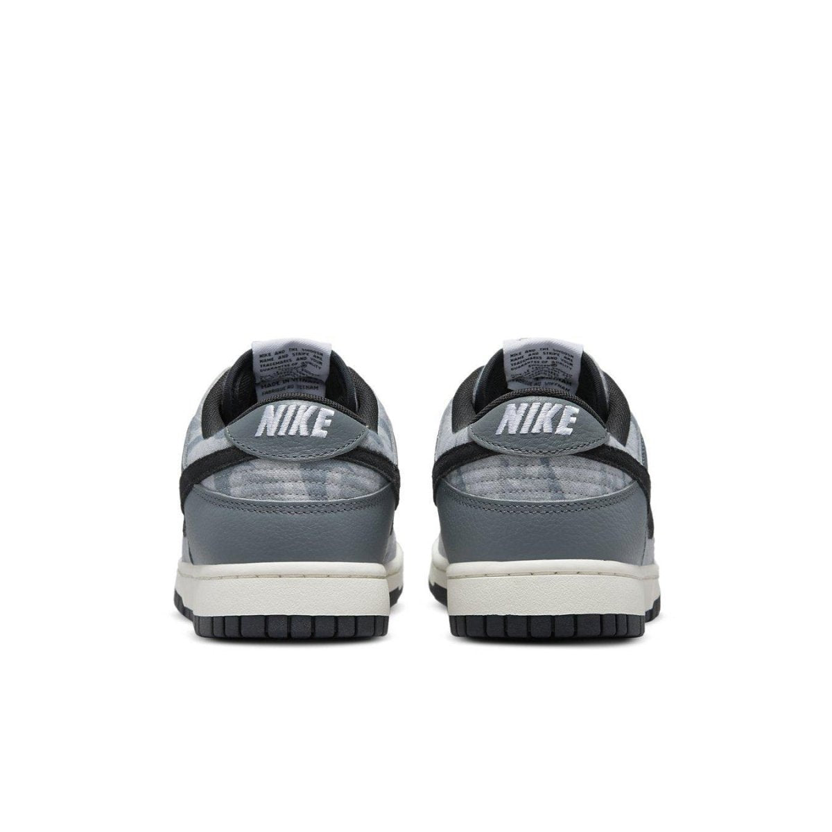 Back view of Nike Dunk Low SE Copy Paste sneakers showcasing sleek gray and black design.