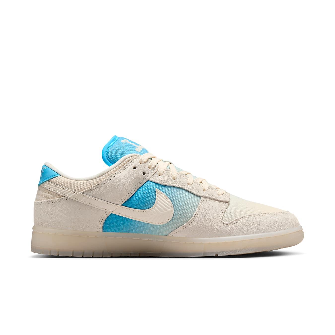 Nike Dunk Low SE Los Angeles sneaker in ivory canvas with blue gradient detailing and suede overlays.