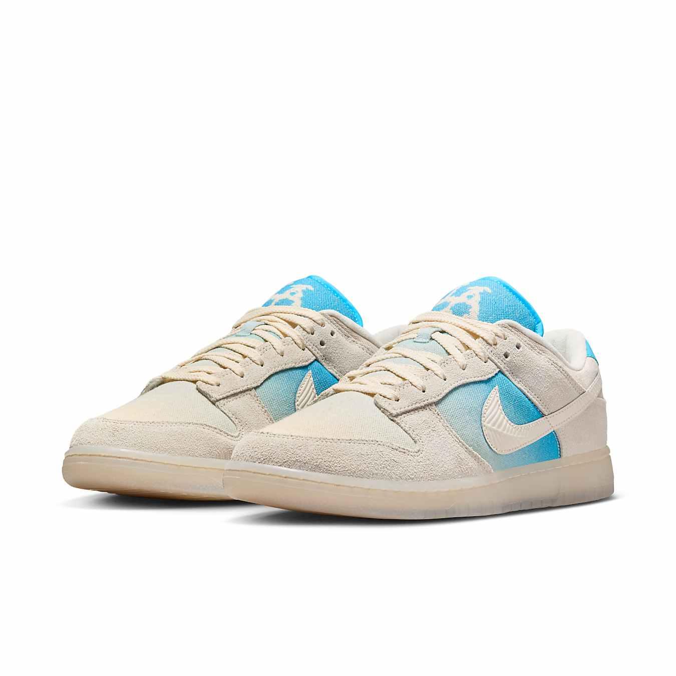 Nike Dunk Low SE 'Los Angeles' sneaker featuring ivory canvas and blue gradient panel.