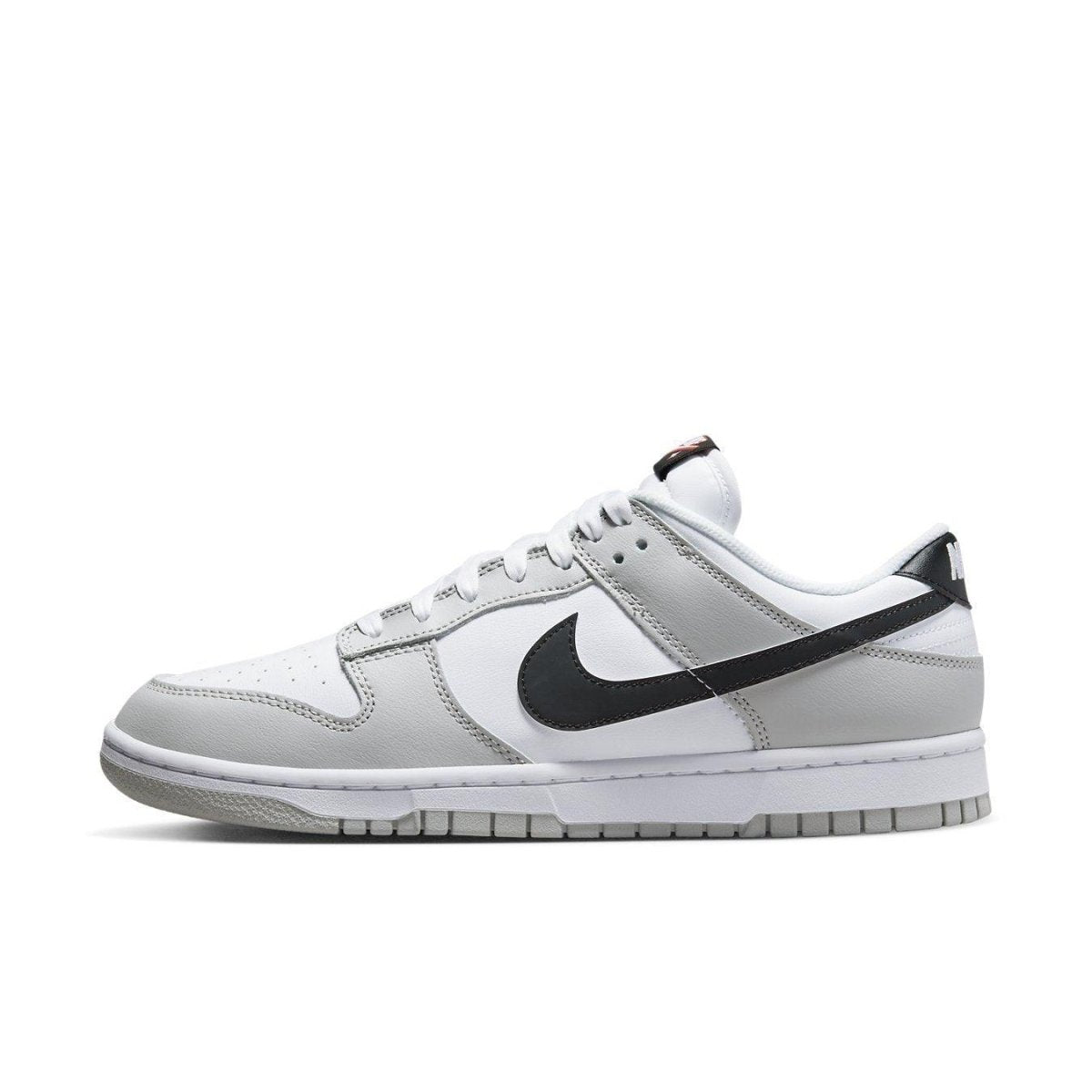 Nike Dunk Low SE Lottery Pack in Grey Fog, featuring white leather and grey overlays with black Swoosh.