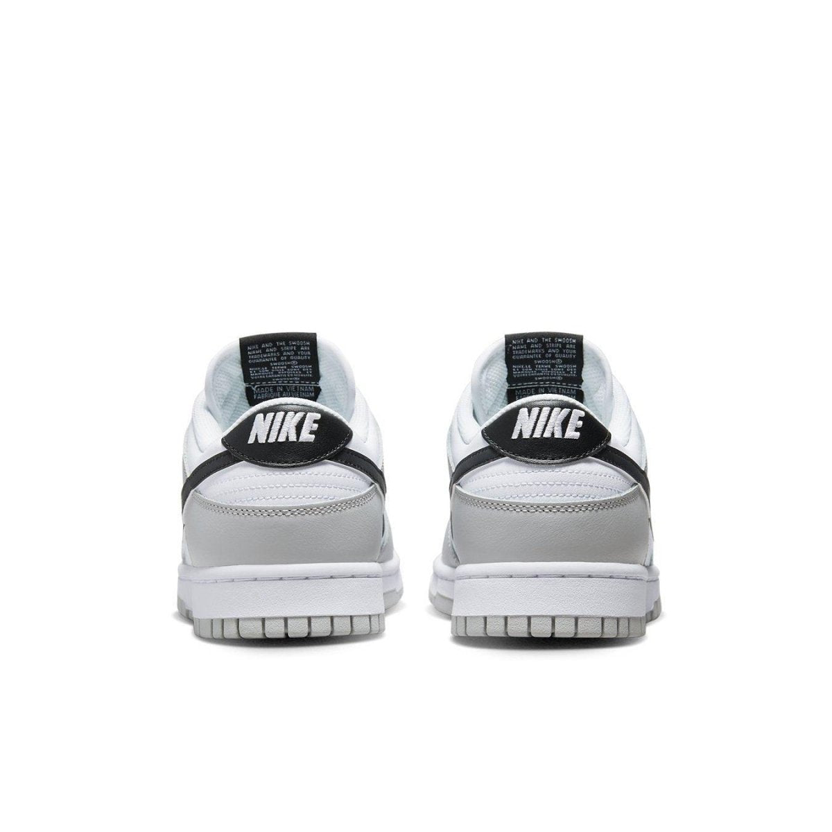 Nike Dunk Low SE Lottery Pack Grey Fog rear view showcasing grey and white leather uppers with black branding.