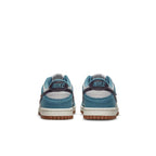 Nike Dunk Low SE Toasty Rift Blue GS sneakers, showing the back view with blue suede and Nike logo on the heel.
