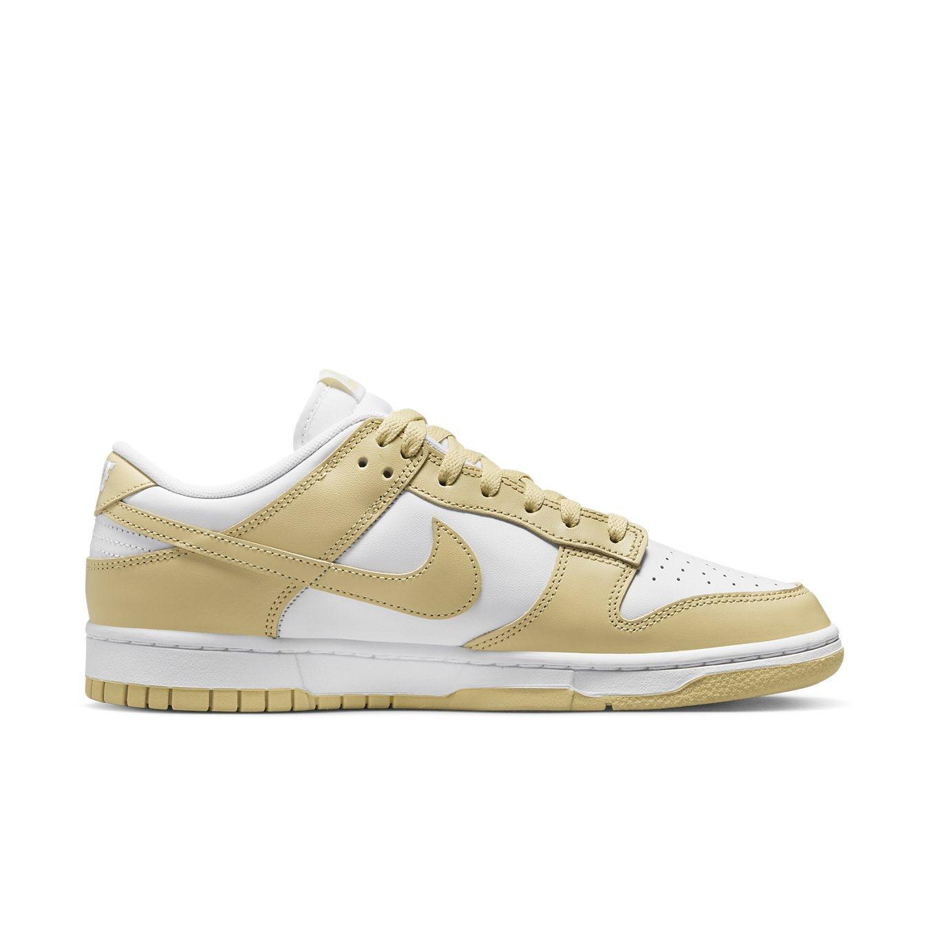 Nike Dunk Low Team Gold in white and light yellow with iconic Swoosh and perforated toe design for breathability.