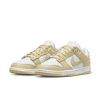Nike Dunk Low Team Gold sneakers with white leather base and soft yellow overlays, showcasing retro style.