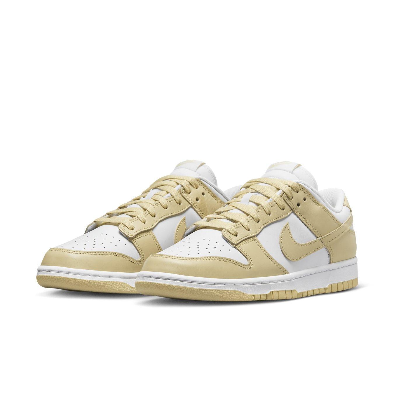 Nike Dunk Low Team Gold sneakers with white leather base and soft yellow overlays, showcasing retro style.