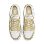 Nike Dunk Low Team Gold sneakers featuring white leather and soft yellow overlays.