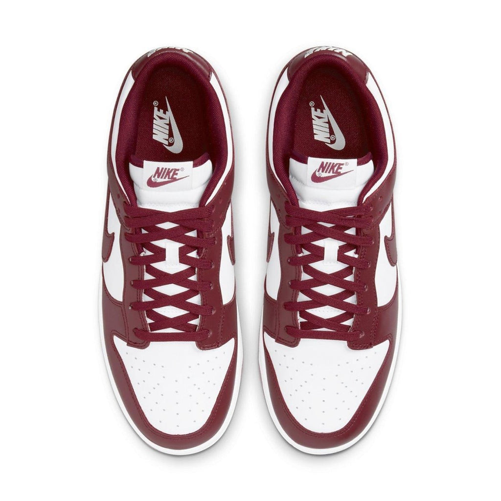 Nike Dunk Low Team Red sneakers featuring white leather base and deep red accents, showcasing classic 1985 style.