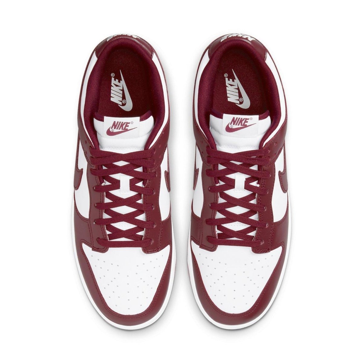 Nike Dunk Low Team Red sneakers featuring white leather base and deep red accents, showcasing classic 1985 style.