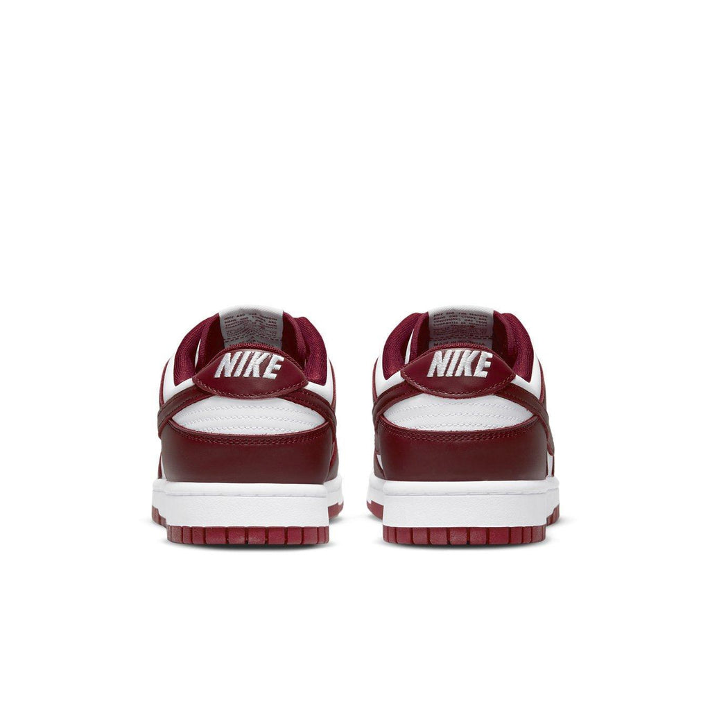 Retro Nike Dunk Low Team Red sneaker with white base and burgundy overlays, featuring embroidered Nike branding on heel.