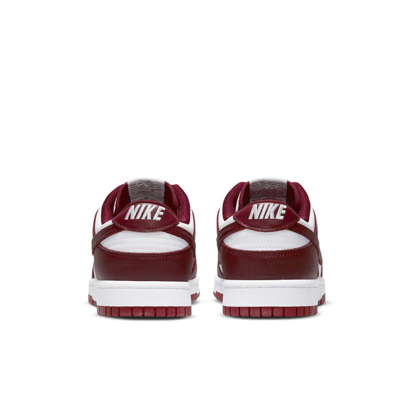 Retro Nike Dunk Low Team Red sneaker with white base and burgundy overlays, featuring embroidered Nike branding on heel.