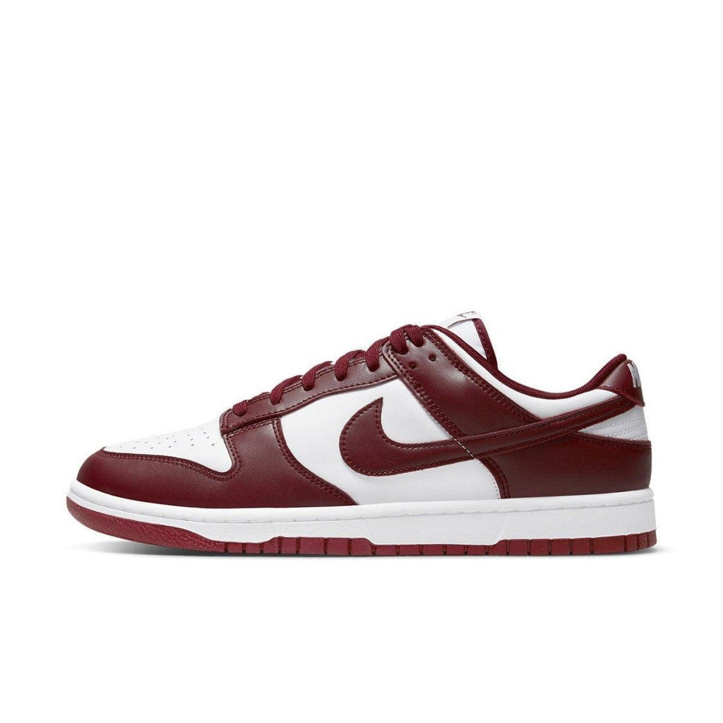 Nike Dunk Low Team Red sneaker featuring a white leather base with bordeaux overlays and classic Nike branding.