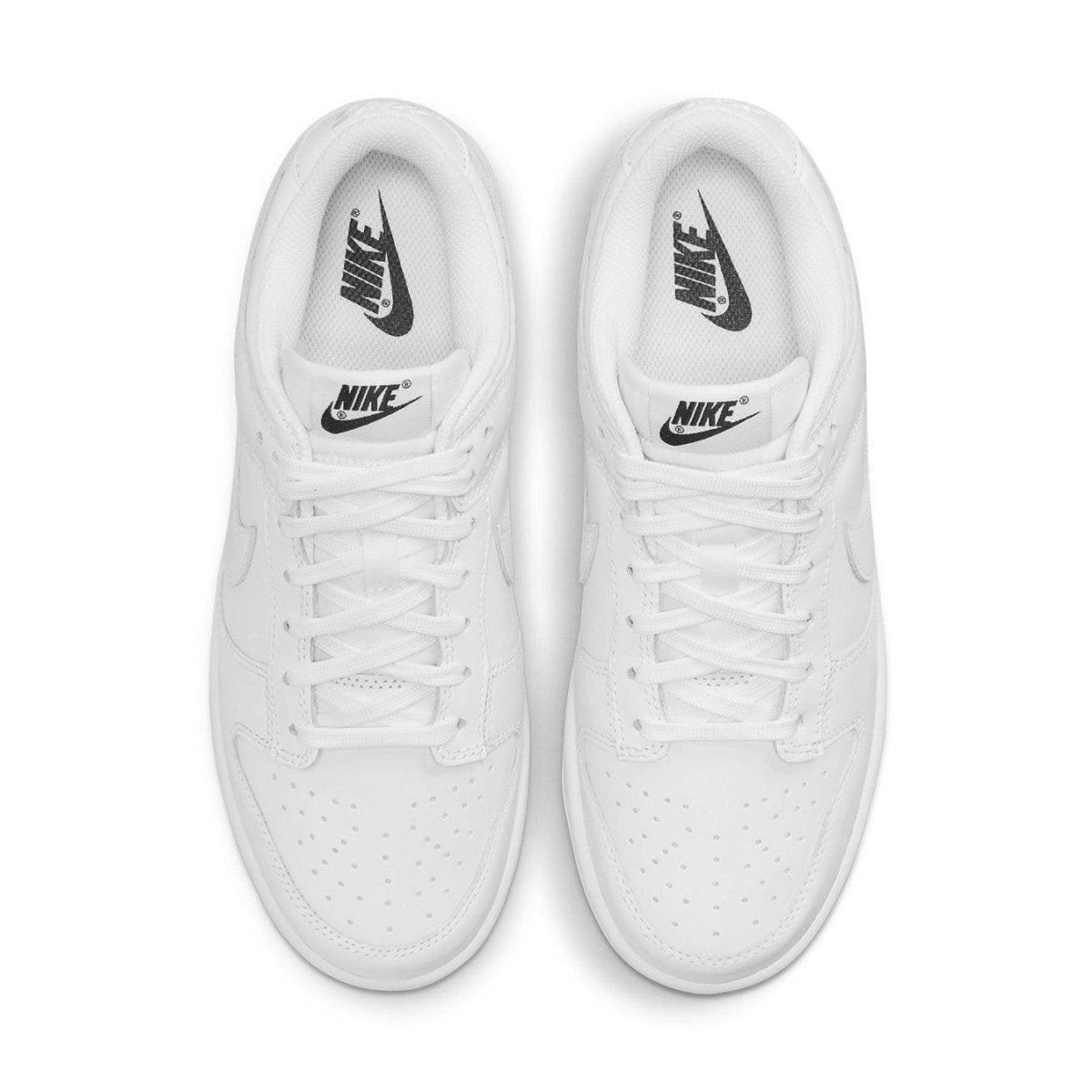 Nike Dunk Low Triple White (2021) women's sneakers, featuring a clean white upper and black branding details.