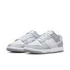 Nike Dunk Low Two Tone Grey sneakers in white leather with gray overlays on eyelets, fender, and heel.