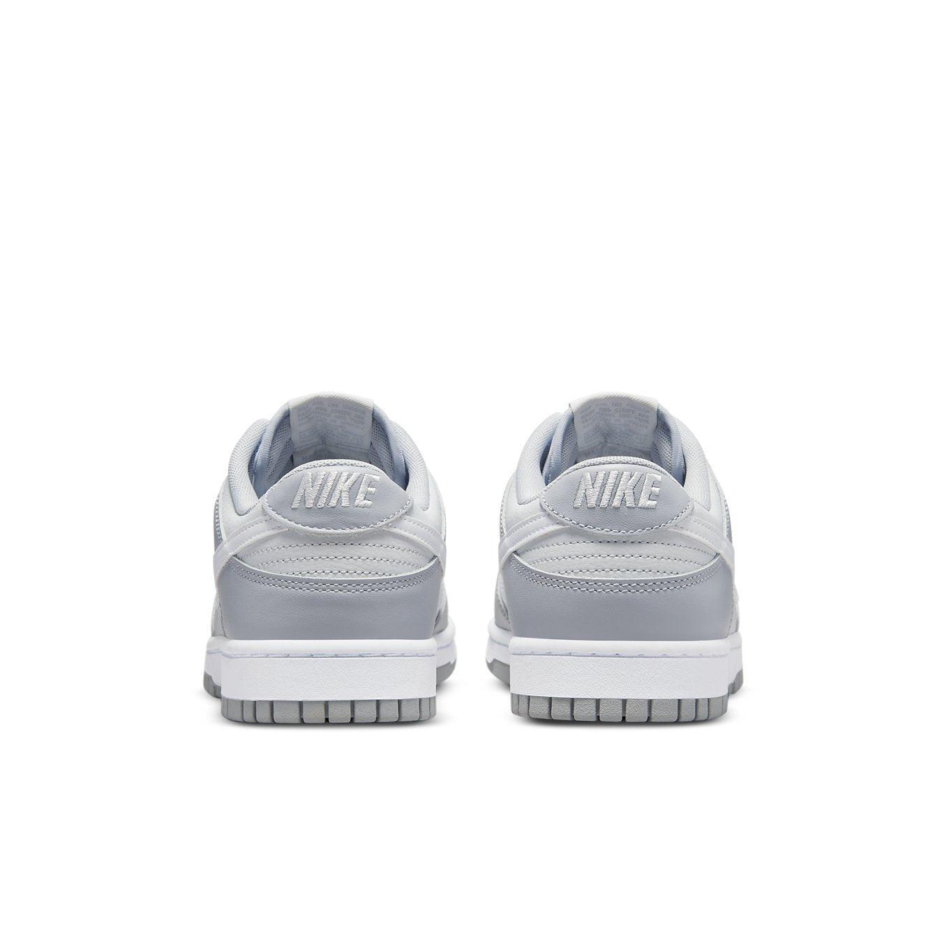 Nike Dunk Low Two Tone Grey sneakers, featuring white leather with grey overlays and Nike branding on the heel.