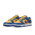 Nike Dunk Low UCLA sneakers in bright yellow and blue colorway with Swoosh and NIKE branding.