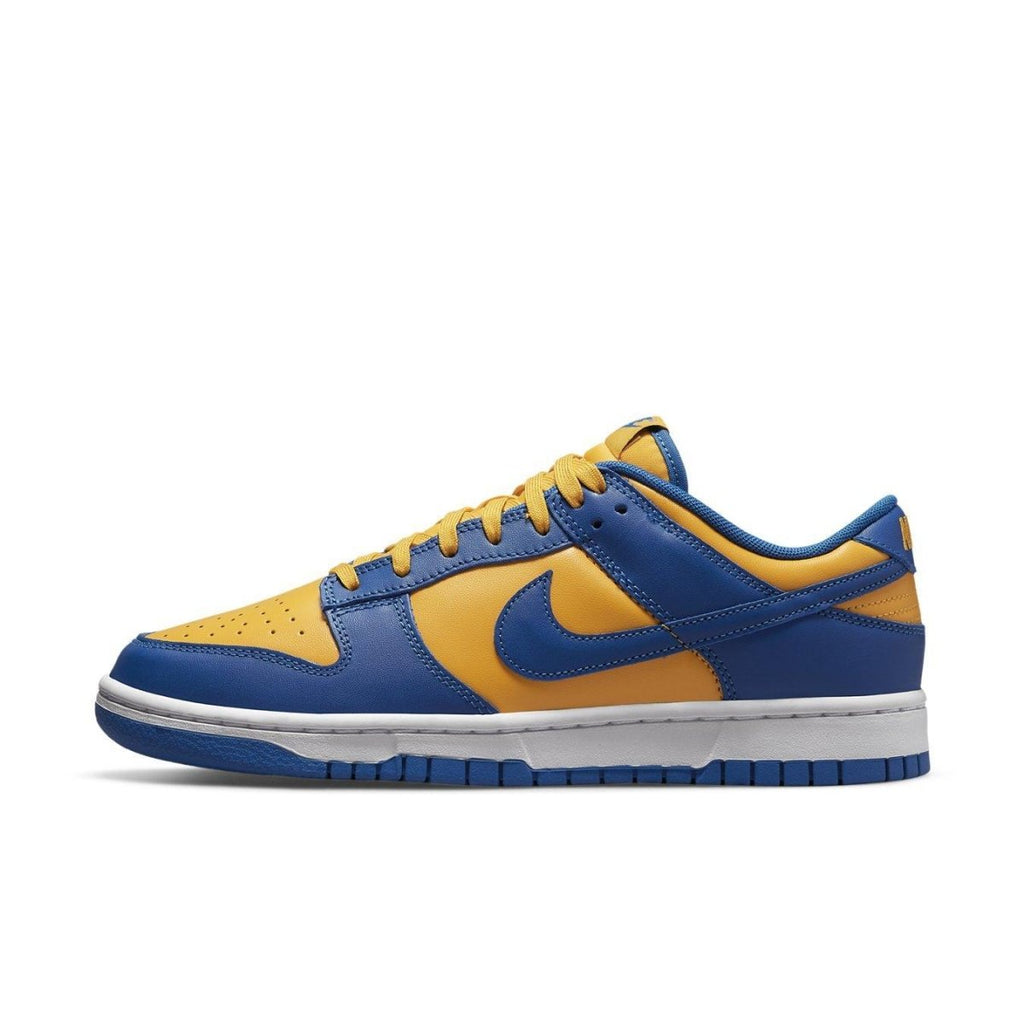 Nike Dunk Low UCLA in blue and yellow leather, featuring Swoosh logo and classic two-tone design.