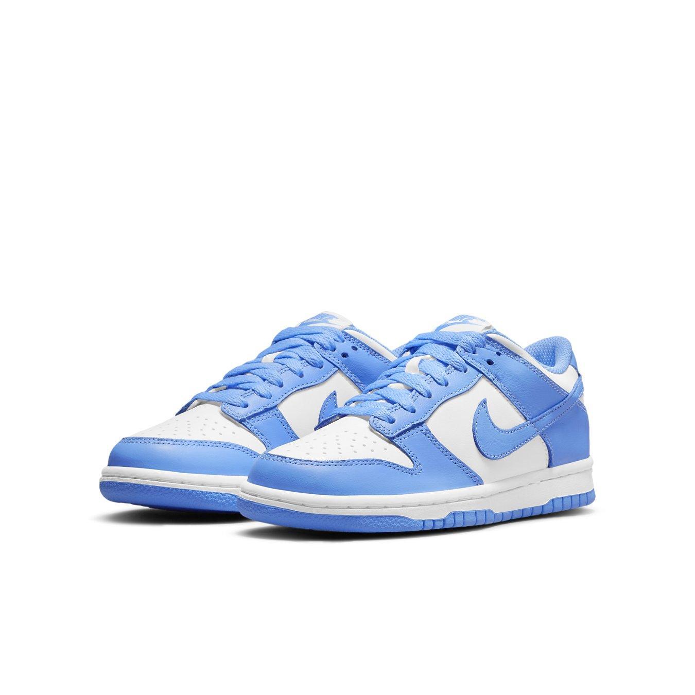 Nike Dunk Low UNC 2021 sneakers in University Blue and white, featuring leather upper and perforated toe.