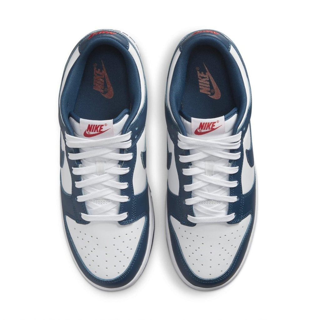 Nike Dunk Low Valerian Blue with white leather and blue accents, featuring red logo details and classic low-top design.