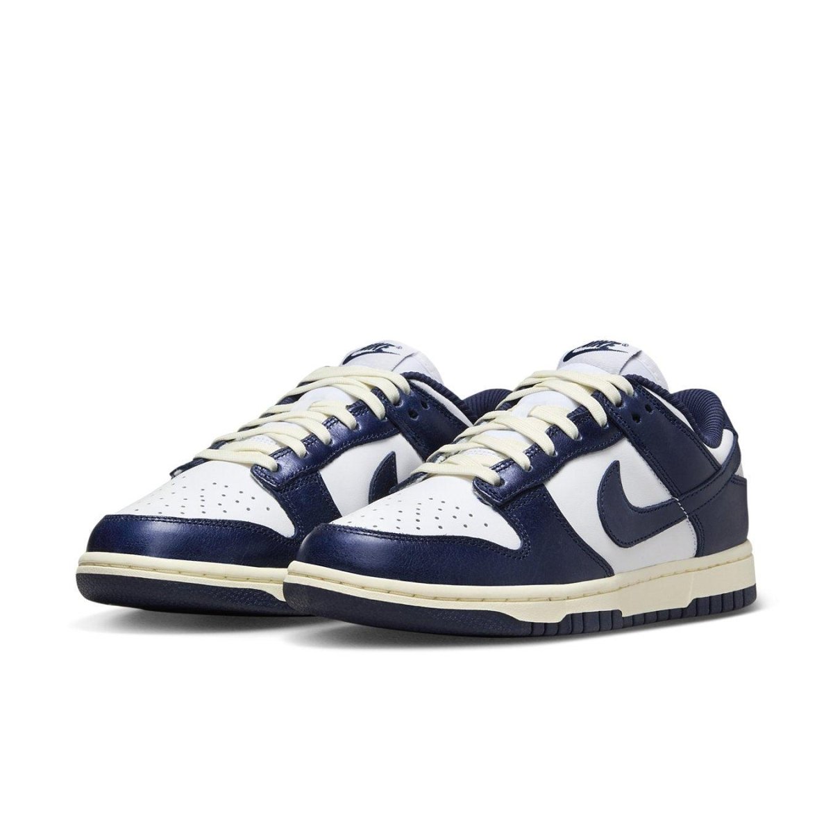 Nike Dunk Low Vintage Navy women's sneakers with white and navy colorway, featuring retro design and classic Swoosh.