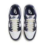 Nike Dunk Low Vintage Navy women's sneakers featuring navy and white colorway with signature Swoosh and lace details.