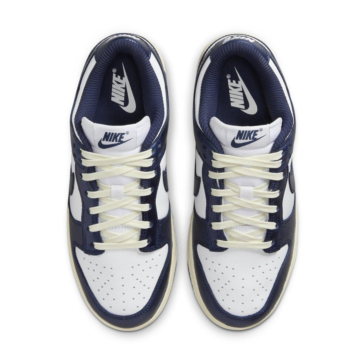Nike Dunk Low Vintage Navy women's sneakers featuring navy and white colorway with signature Swoosh and lace details.