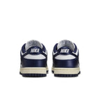 Nike Dunk Low Vintage Navy women's sneakers, rear view showcasing navy blue and white colorway with Nike branding.