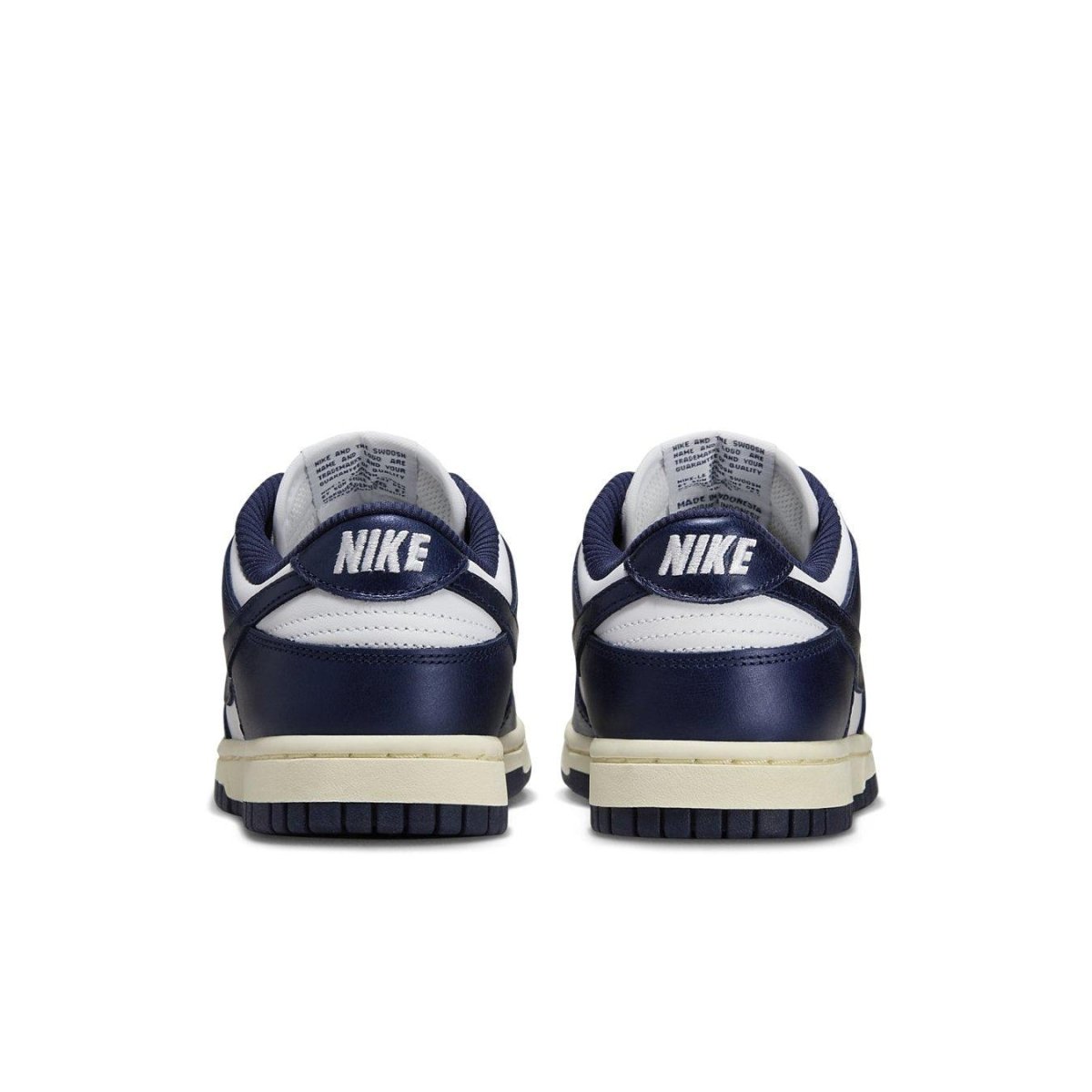 Nike Dunk Low Vintage Navy women's sneakers, rear view showcasing navy blue and white colorway with Nike branding.