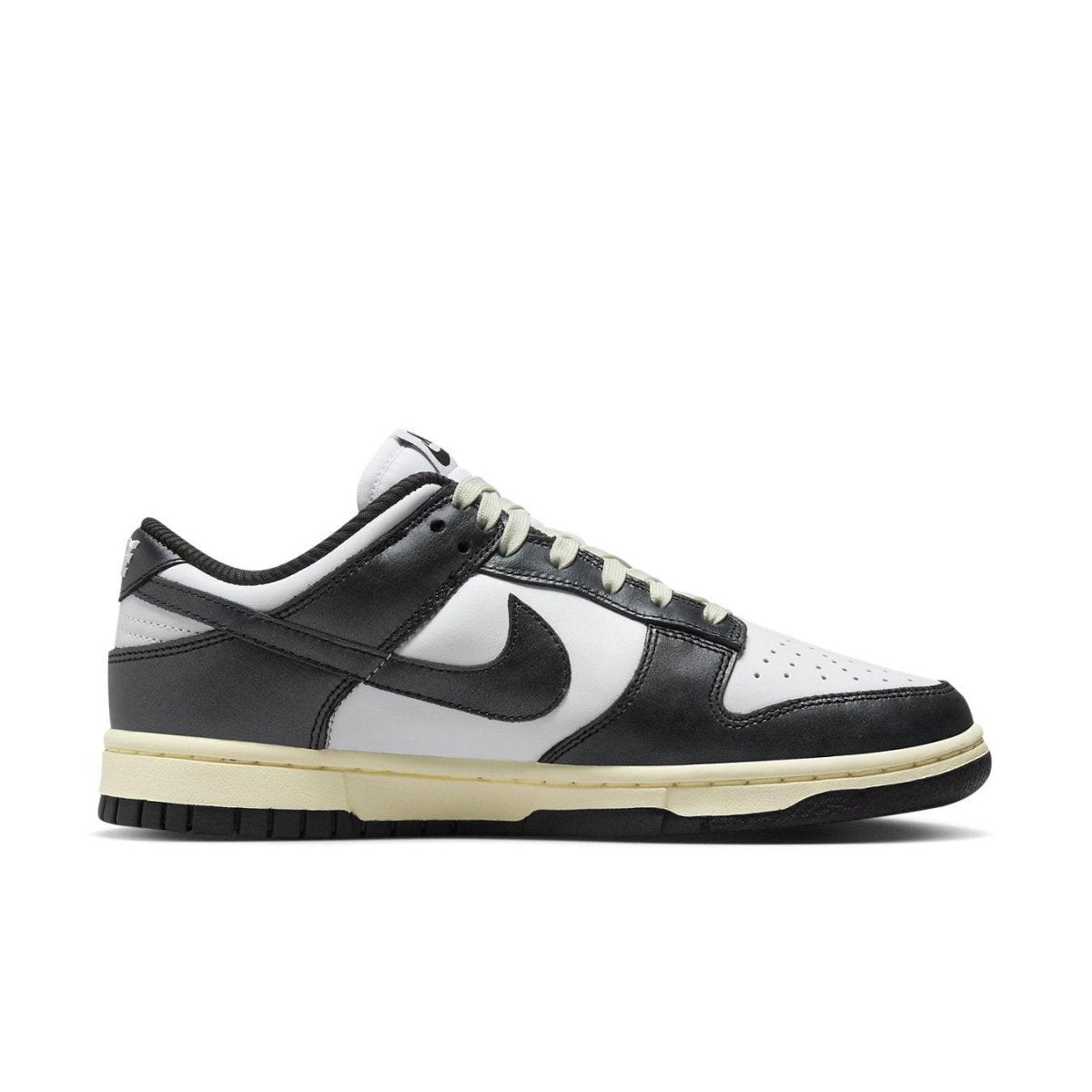 Nike Dunk Low Vintage Panda Women's sneaker with black and white leather, vintage ivory sole.