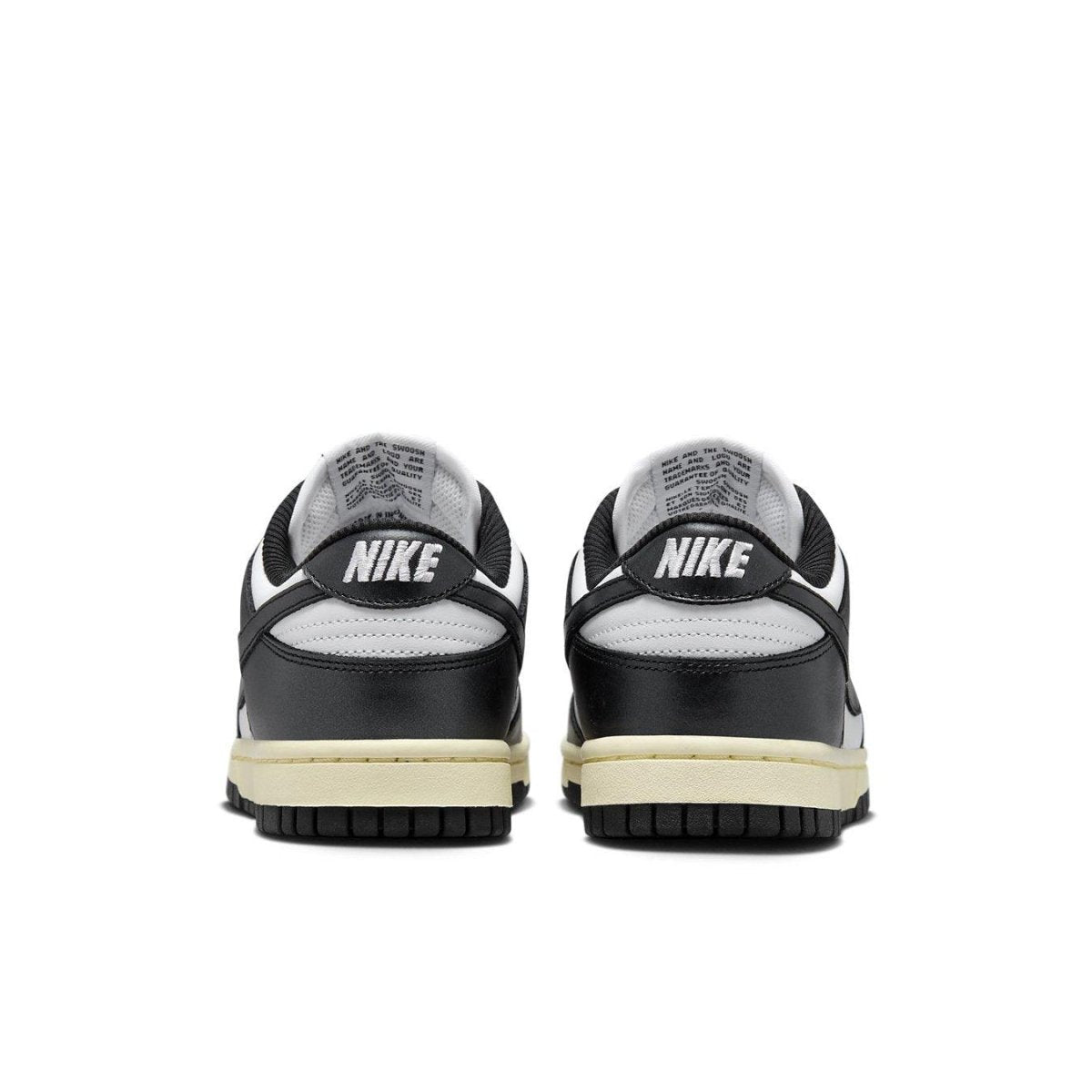 Nike Dunk Low Vintage Panda women's sneakers, showing the back view with black and ivory tones.