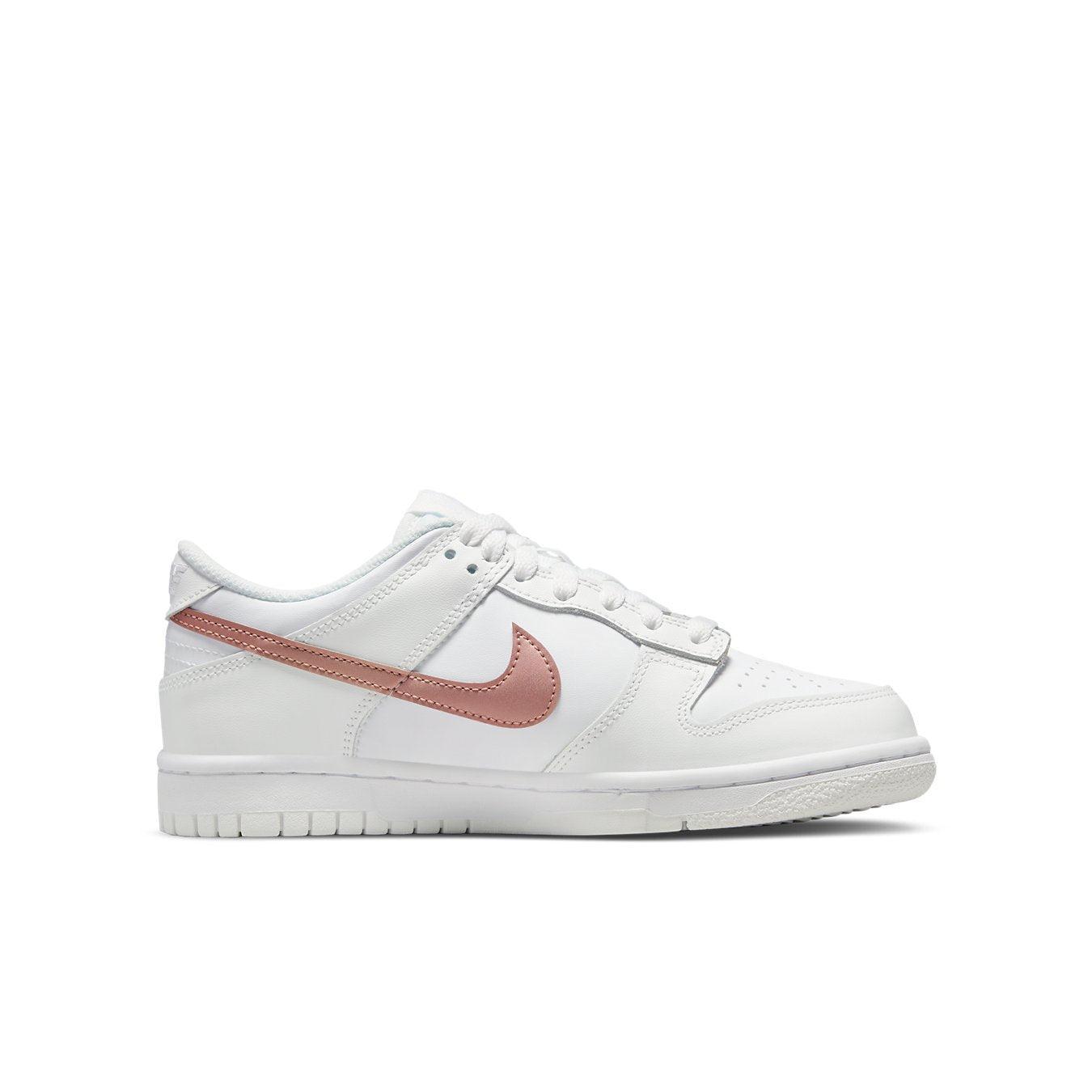 Nike Dunk Low White Pink (GS) sneaker, featuring white leather upper and bronze Swoosh for a stylish look.