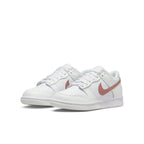 Nike Dunk Low in white and pink, featuring premium leather and lightweight cushioning for everyday wear.