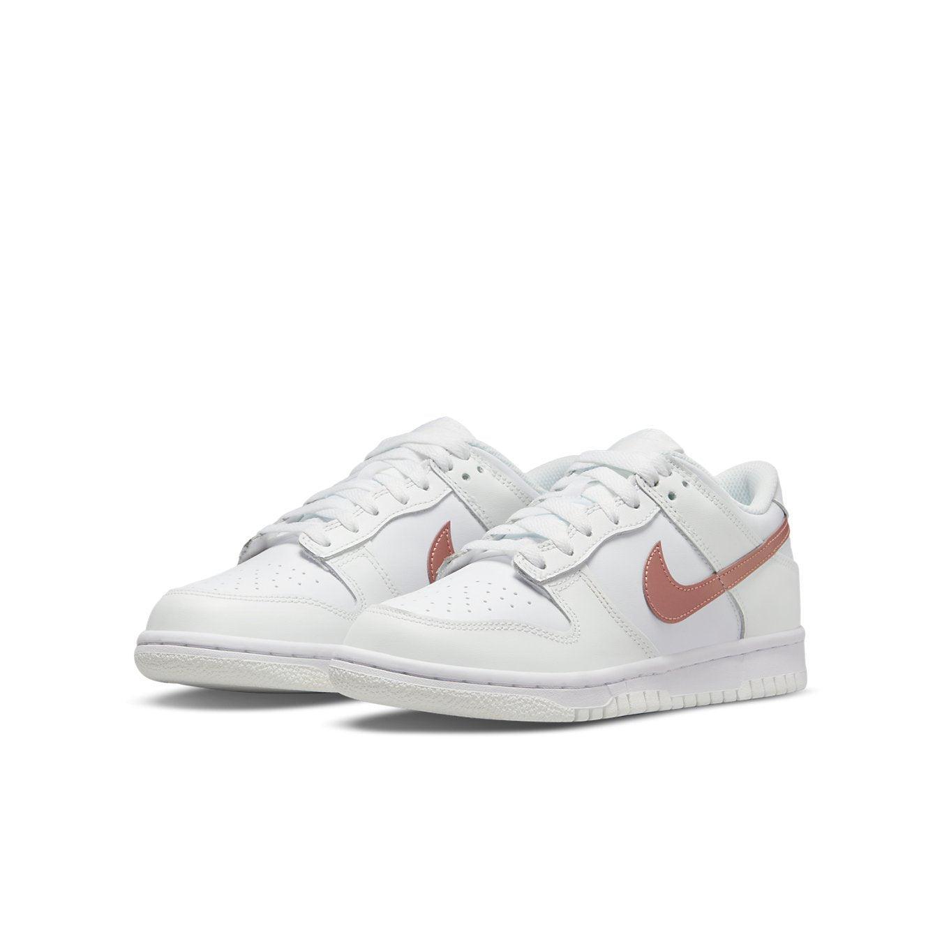 Nike Dunk Low in white and pink, featuring premium leather and lightweight cushioning for everyday wear.