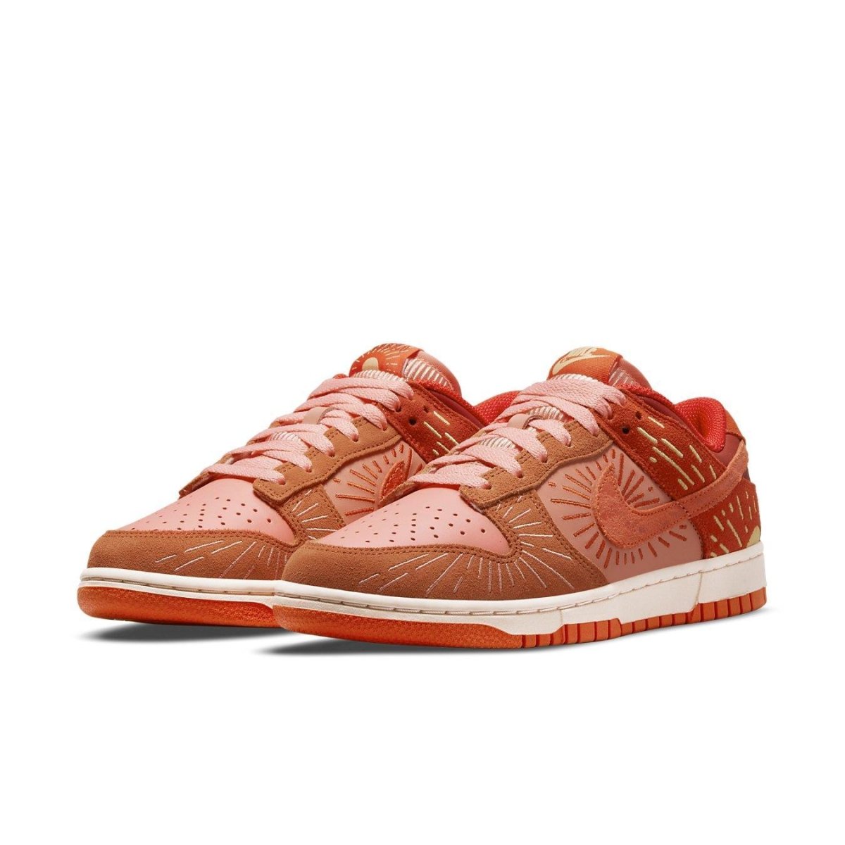 Nike Dunk Low Winter Solstice women's sneakers featuring pink leather and burnt orange suede overlays.