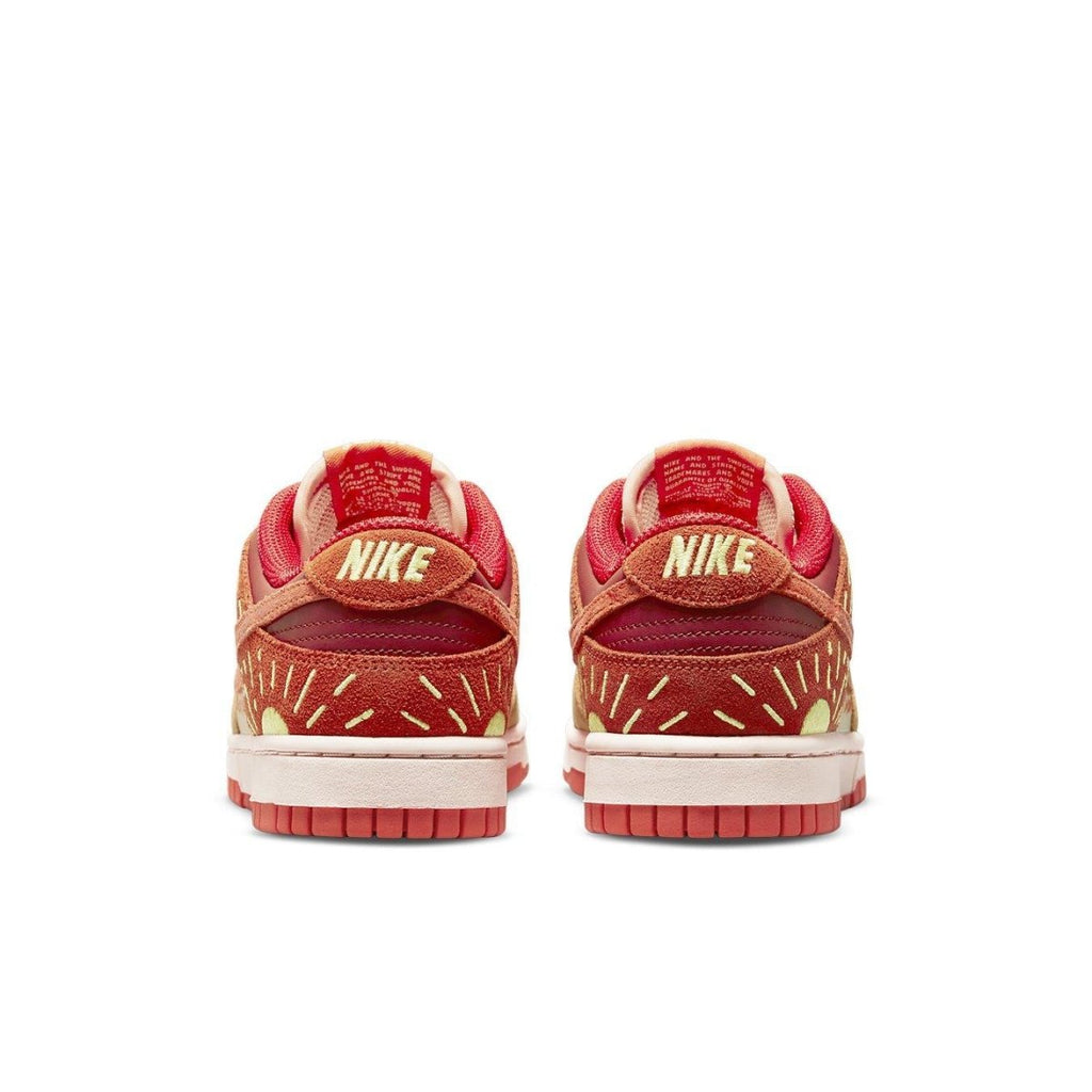 Nike Dunk Low Winter Solstice women's sneakers showing the back with radiant sunburst design and pink leather accents.
