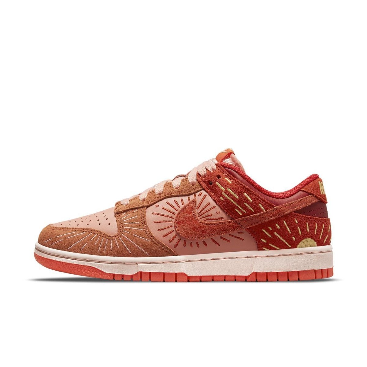 Nike Dunk Low Winter Solstice women's sneaker in pink and burnt orange with sun motif.