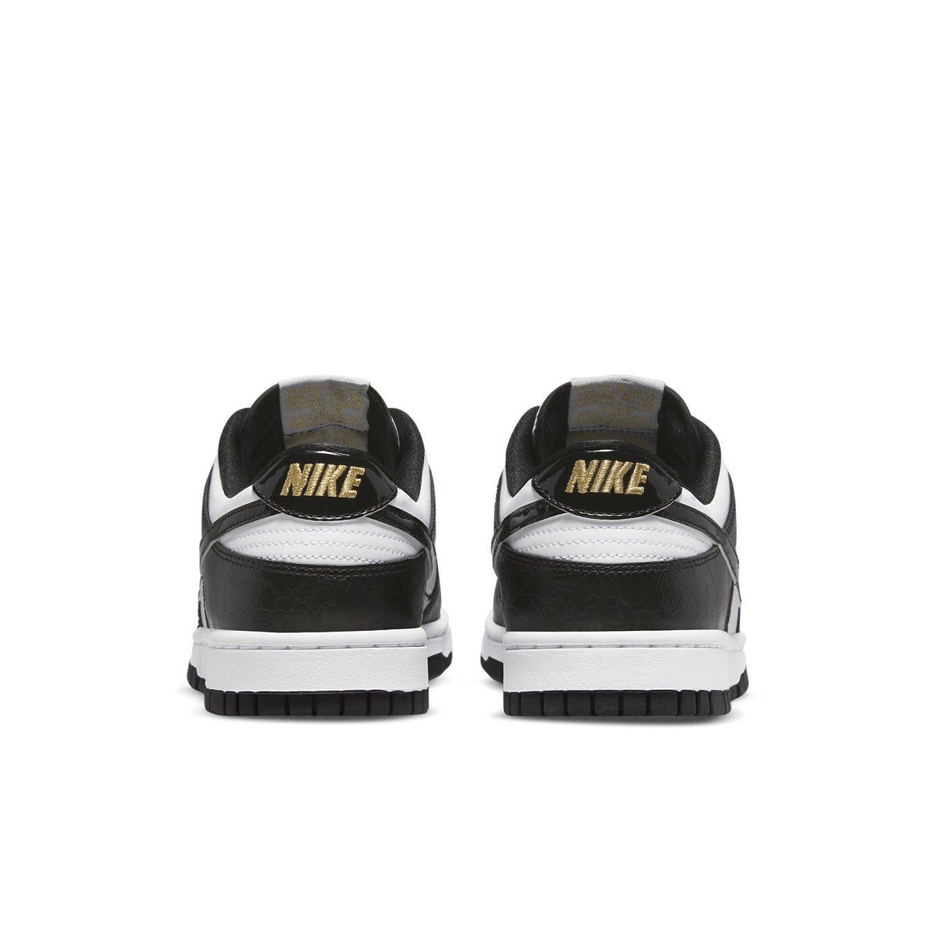 Nike Dunk Low World Champs Black White rear view with shiny overlays and gold accents on the laces.