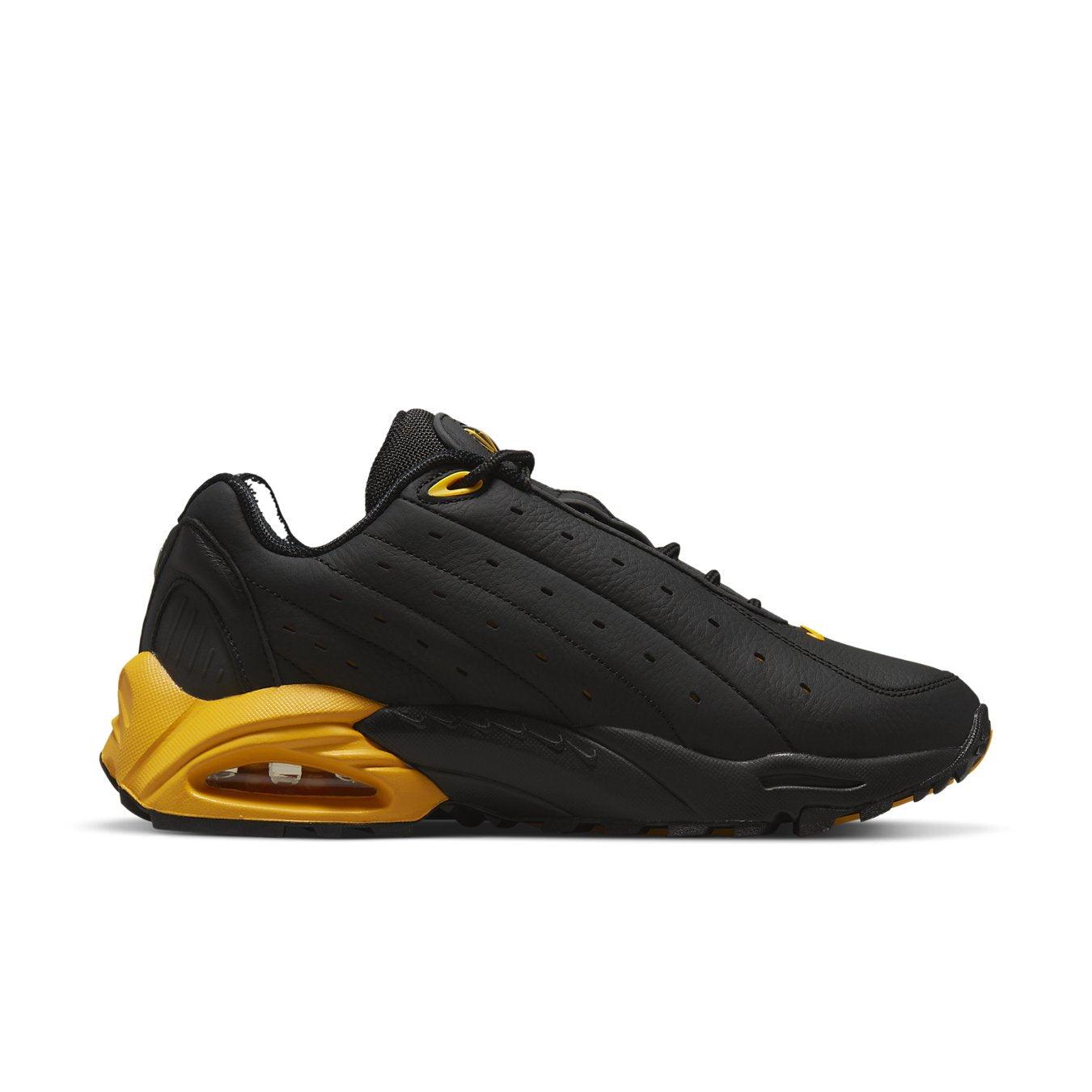 Nike Hot Step Air Terra Drake NOCTA in black and yellow, featuring a sleek design with reflective details.