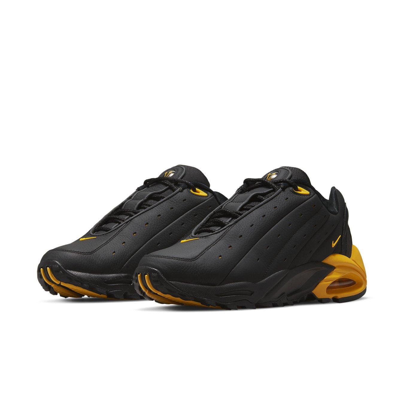 Nike Hot Step Air Terra Drake NOCTA in black and yellow, featuring reflective details and unique design.