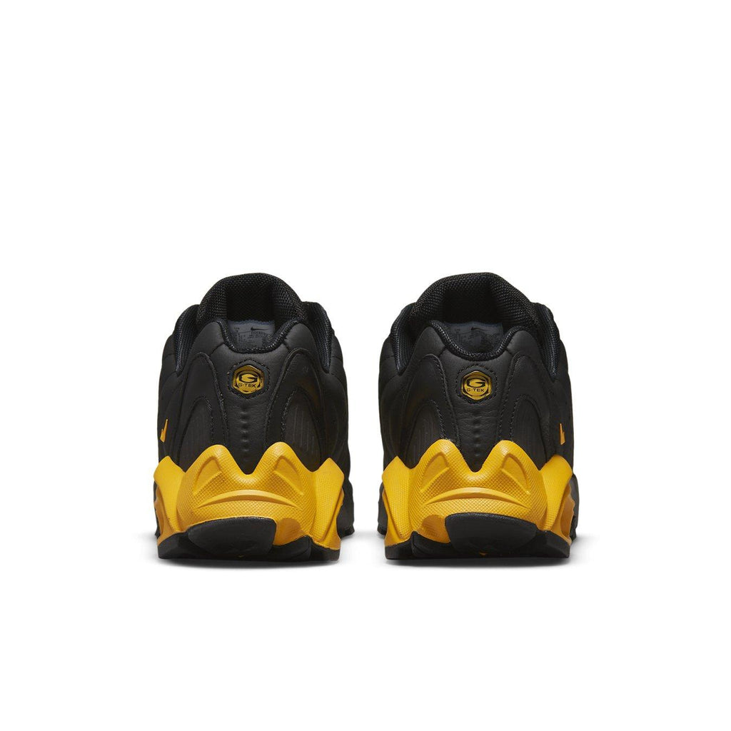 Nike Hot Step Air Terra Drake NOCTA black and yellow sneaker, back view showcasing unique design elements.