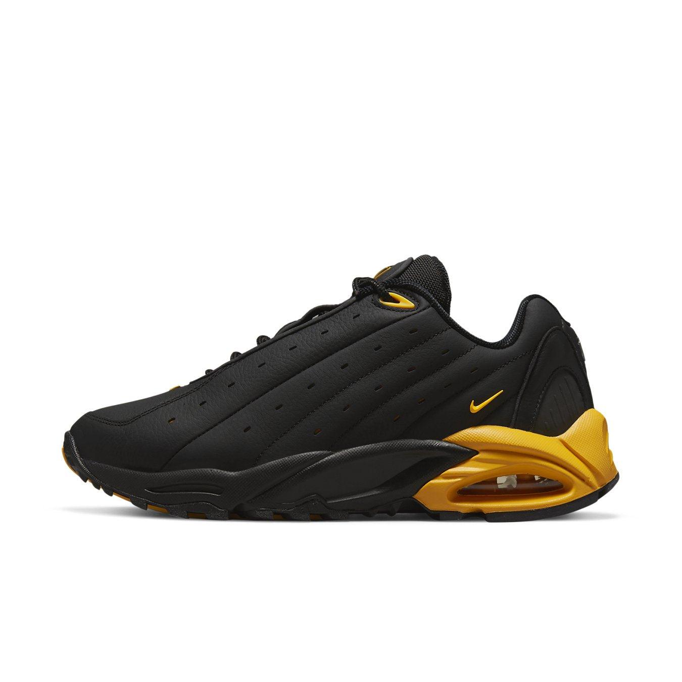 Nike Hot Step Air Terra Drake NOCTA in black and university gold, showcasing sleek design and reflective accents.