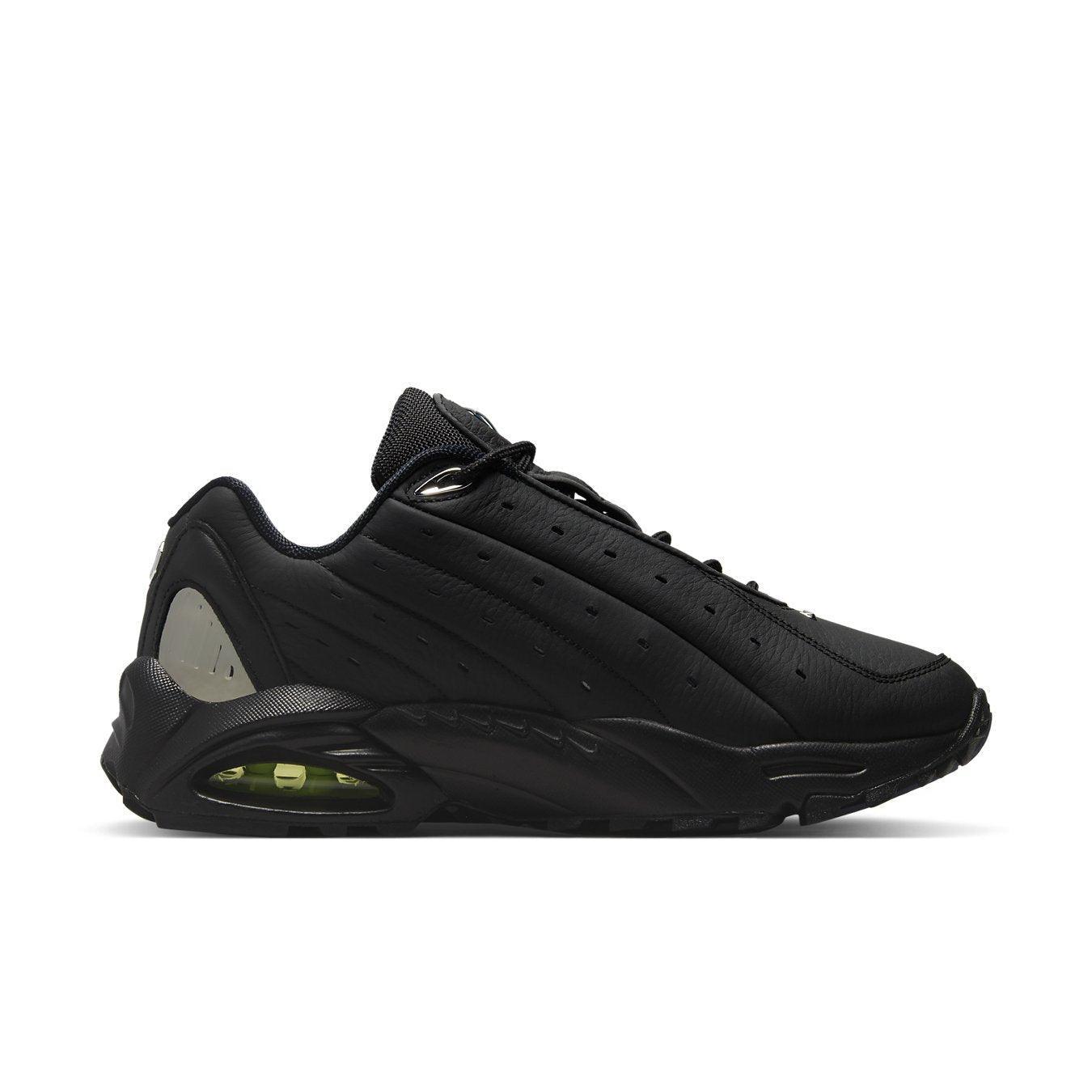 Nike Hot Step Air Terra Drake NOCTA Triple Black side view showing sleek black leather upper and distinctive design features.